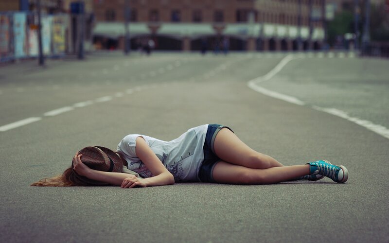 Woman lying on street