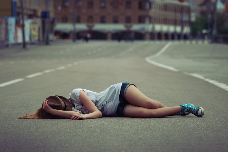 Woman lying on the street