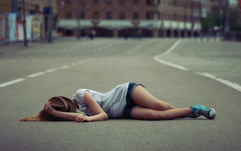 Woman lying on the street