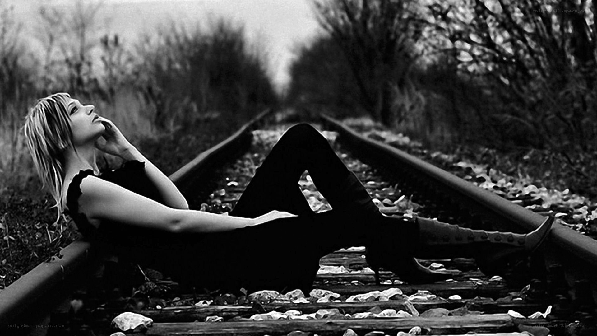 woman lying on train tracks