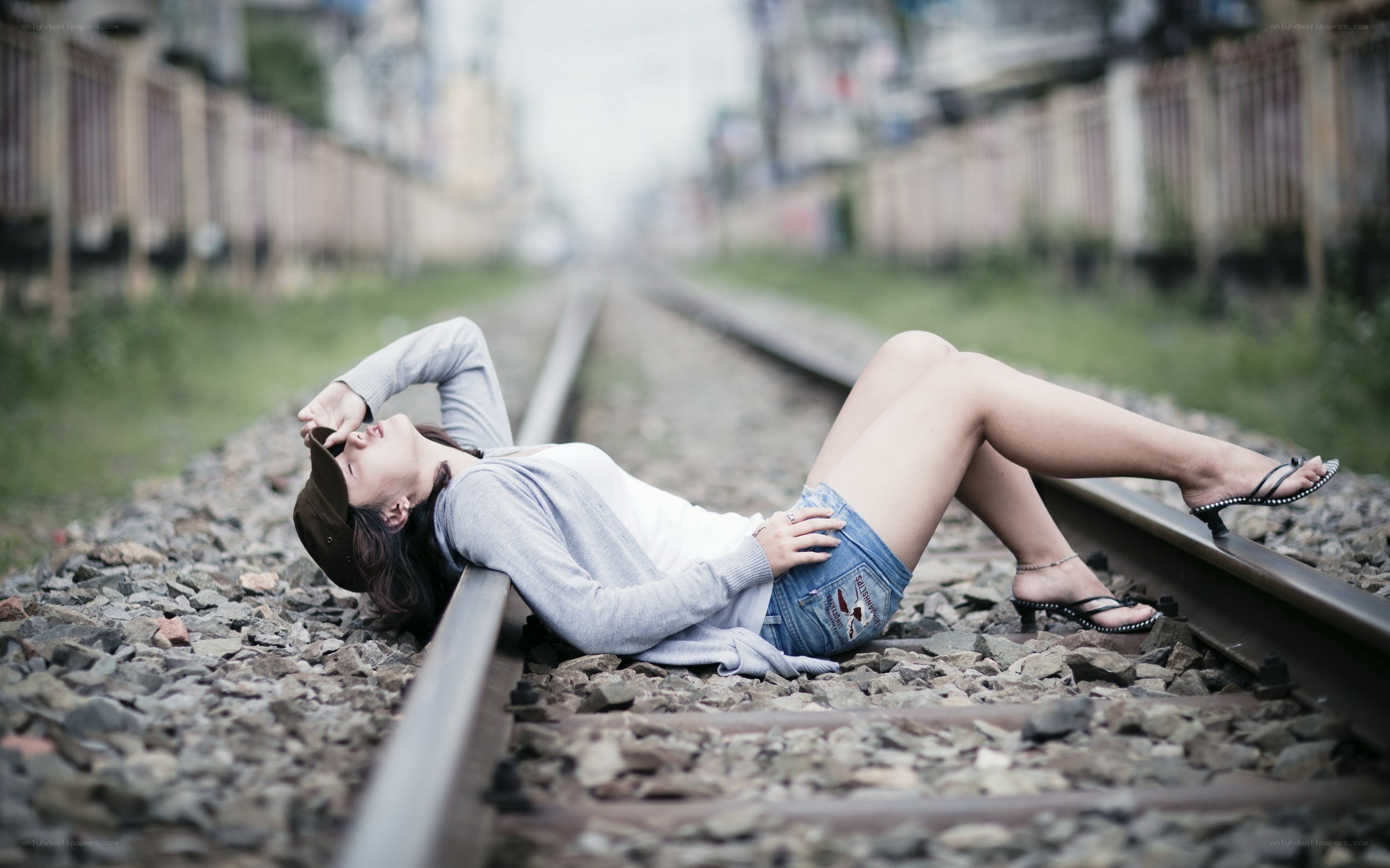 Woman lying on train tracks