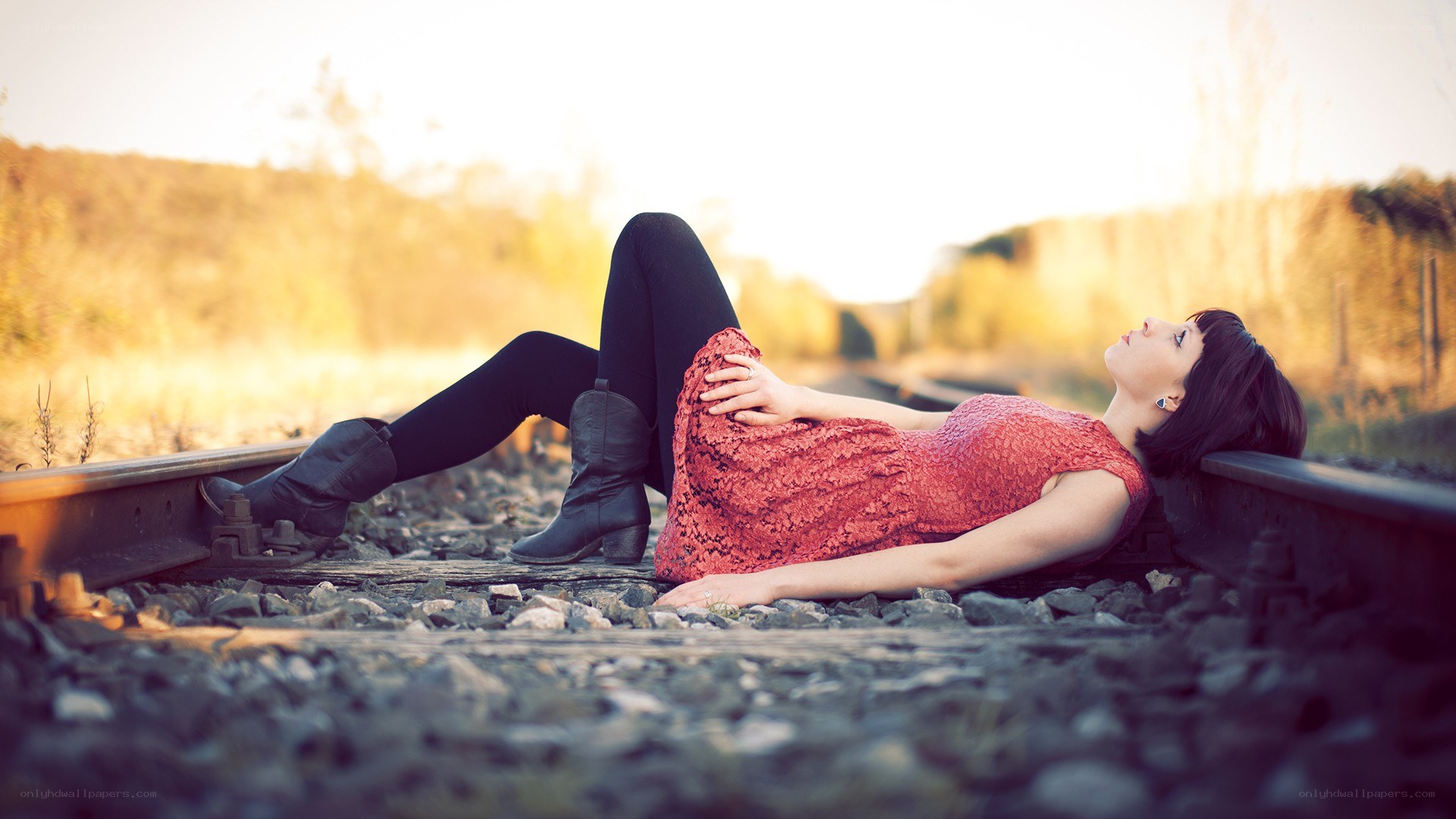 Woman lying on train tracks