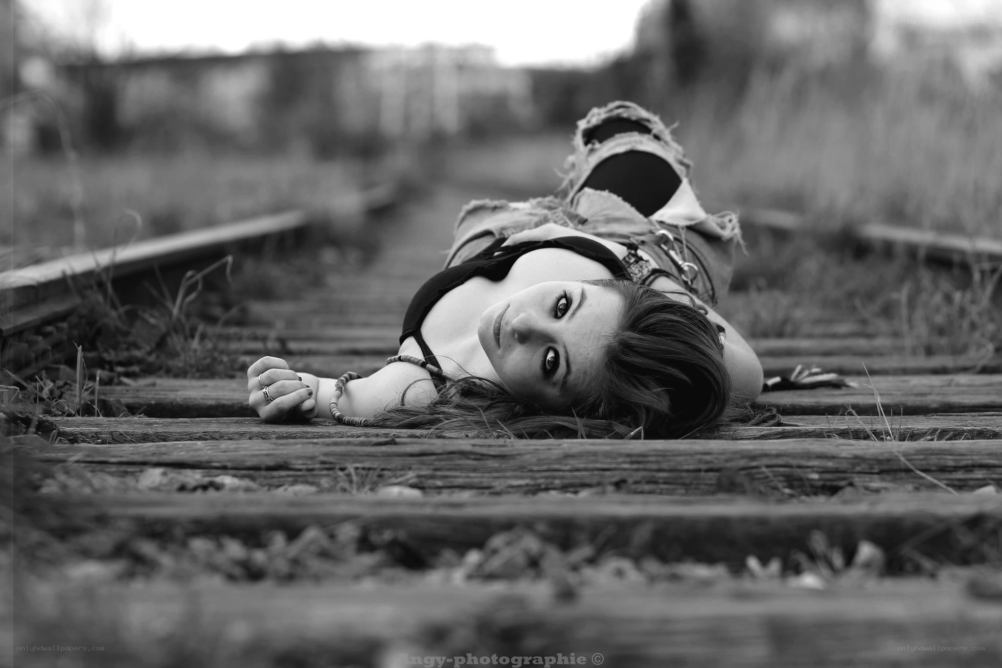 woman lying on train tracks