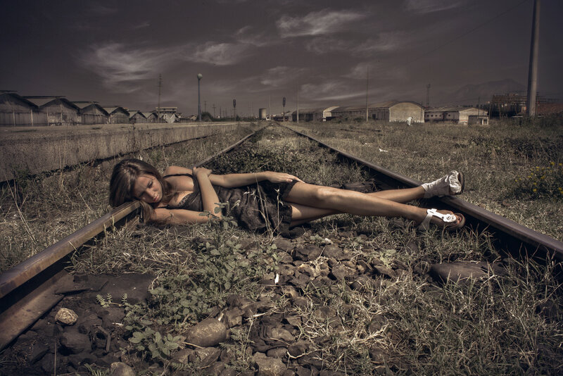 Woman Lying on Train Tracks — Brown