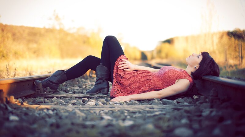 Woman Lying on Train Tracks — Red