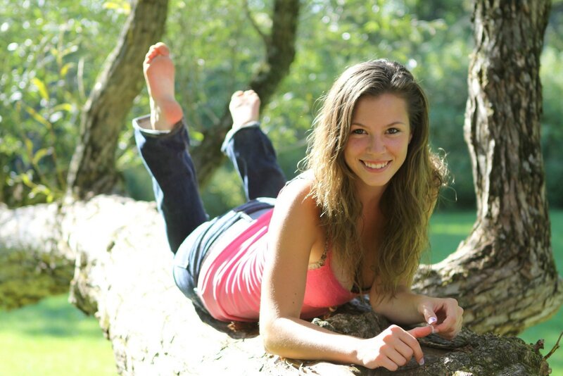 woman lying on tree branch
