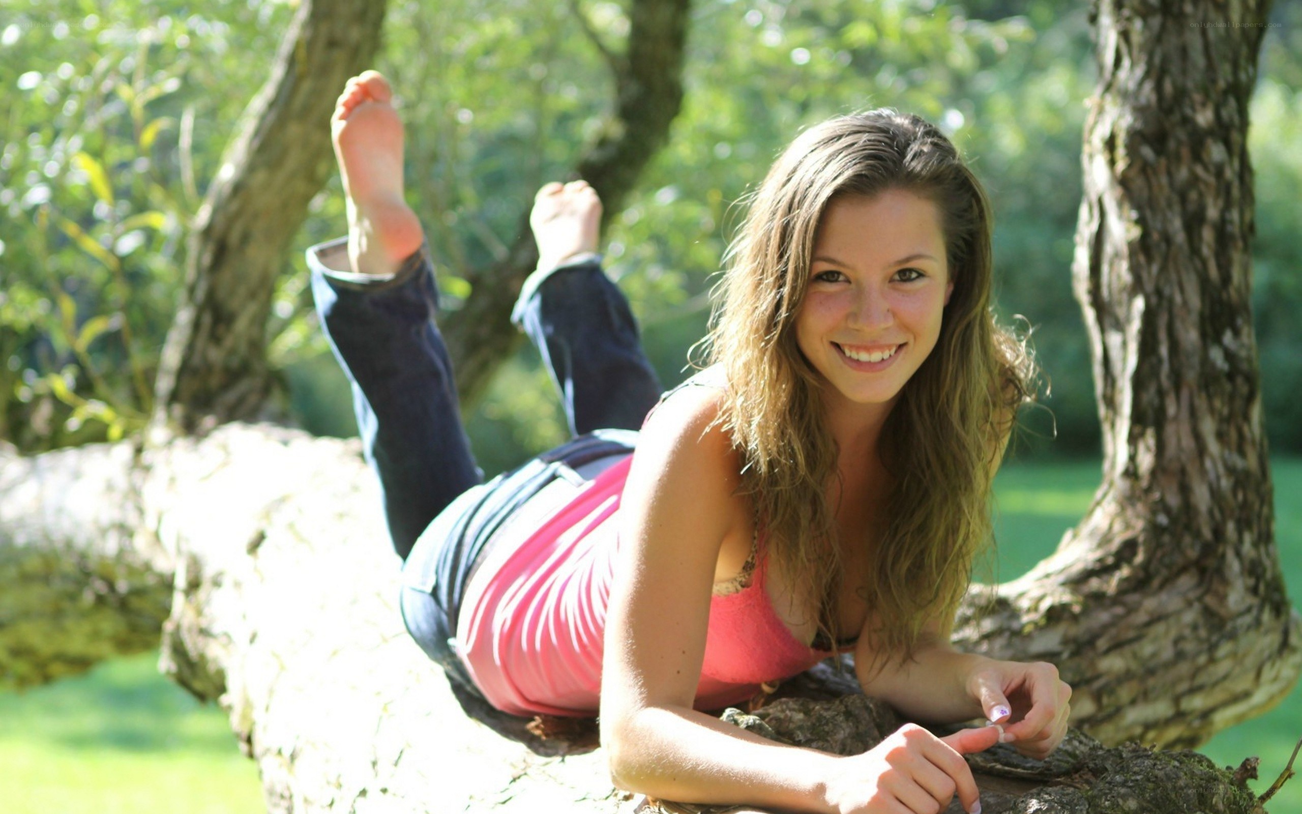 woman lying on tree branch