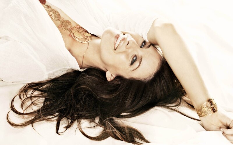 woman lying on white bed