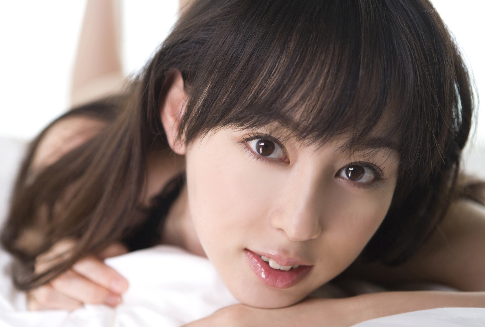 woman lying on white bedding