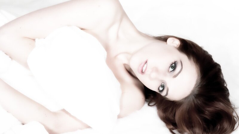 woman lying on white blanket