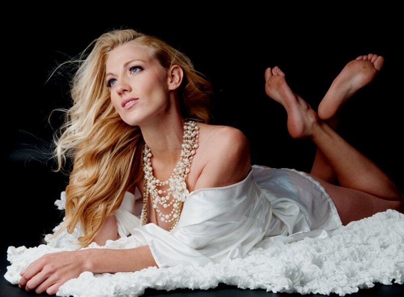 Woman Lying on White Blanket — Dramatic