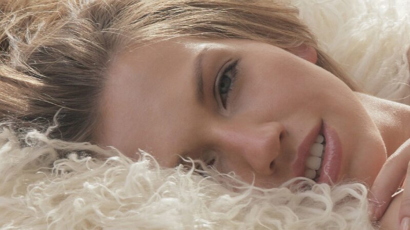 woman lying on white fur