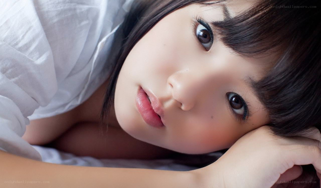 woman lying on white sheets