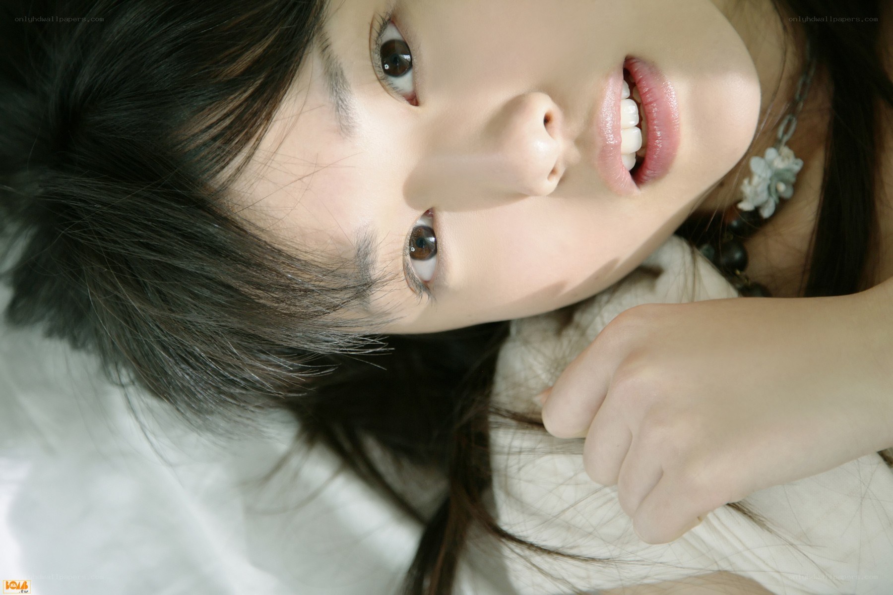 woman lying on white surface