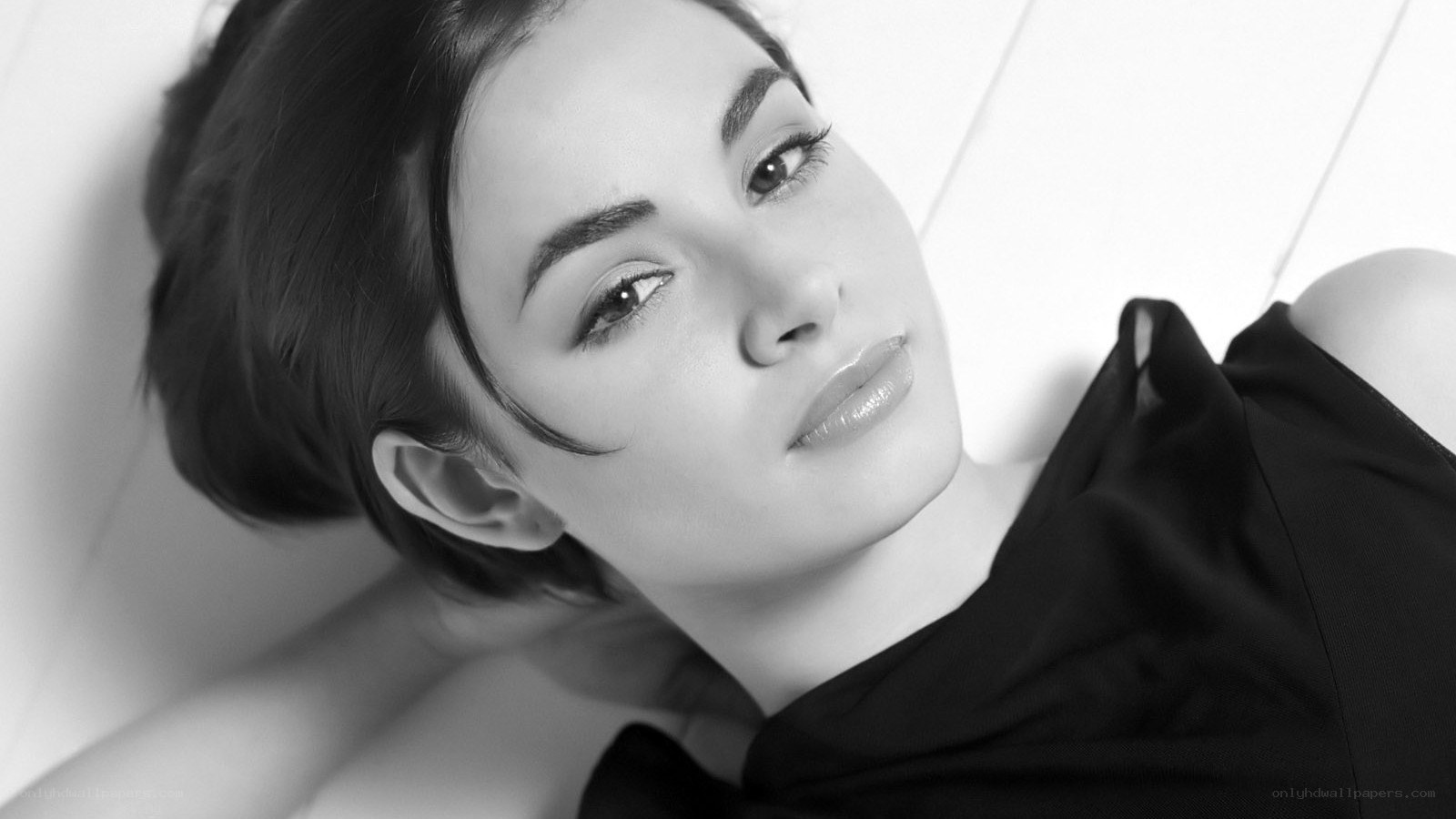 woman lying on white surface