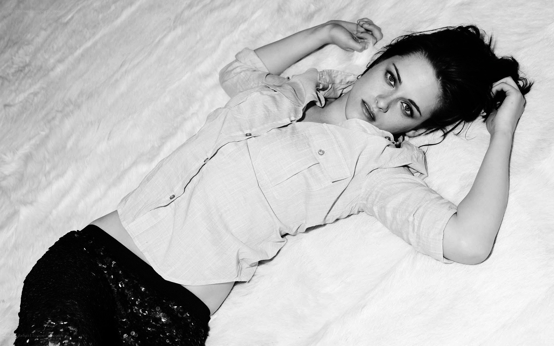 woman lying on white surface