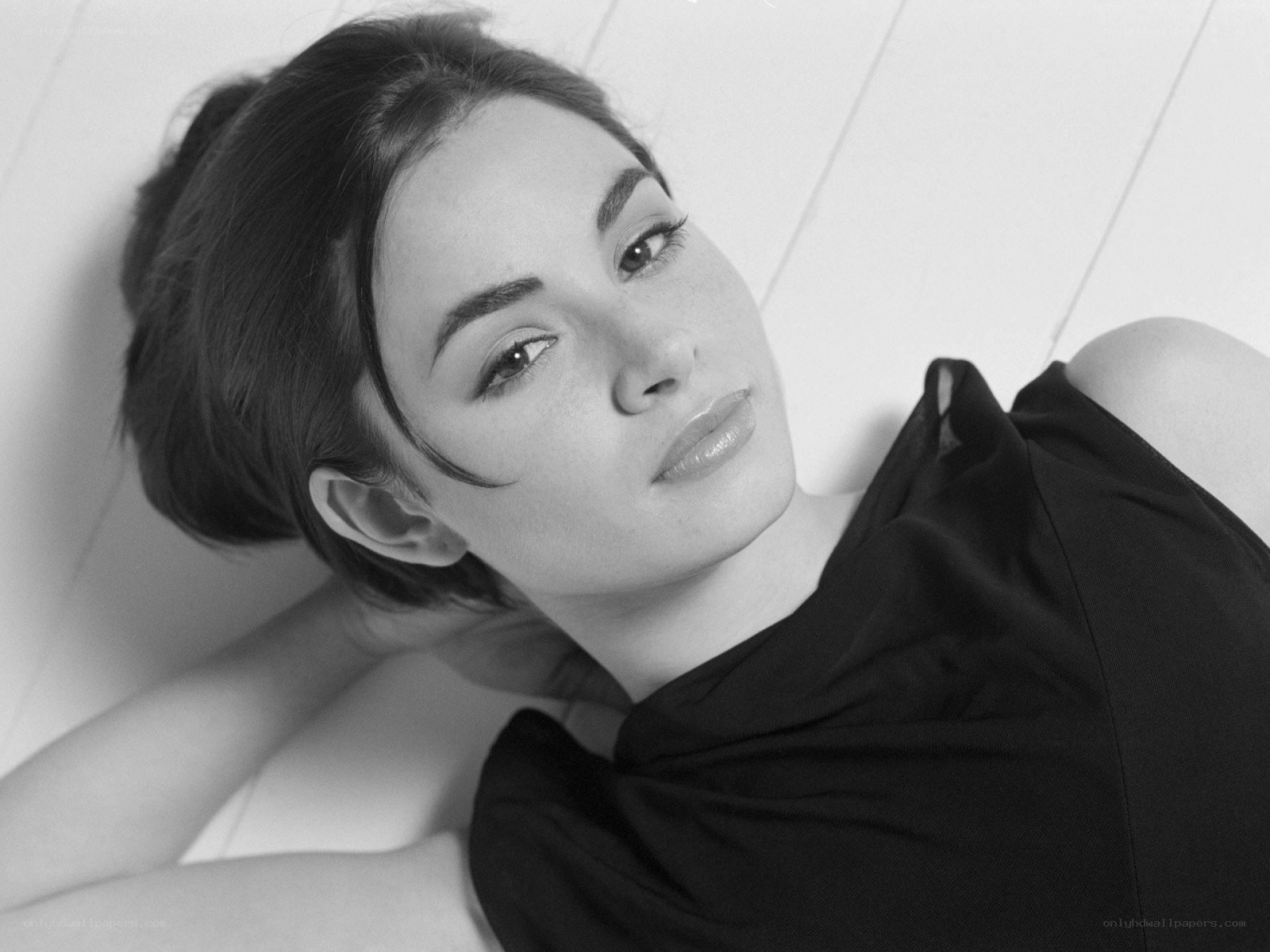 woman lying on white surface