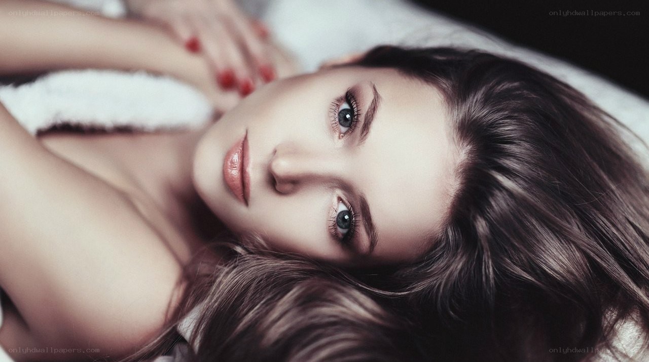 woman lying on white surface