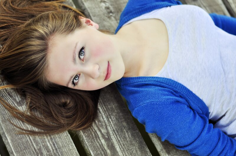 woman lying on wooden bench