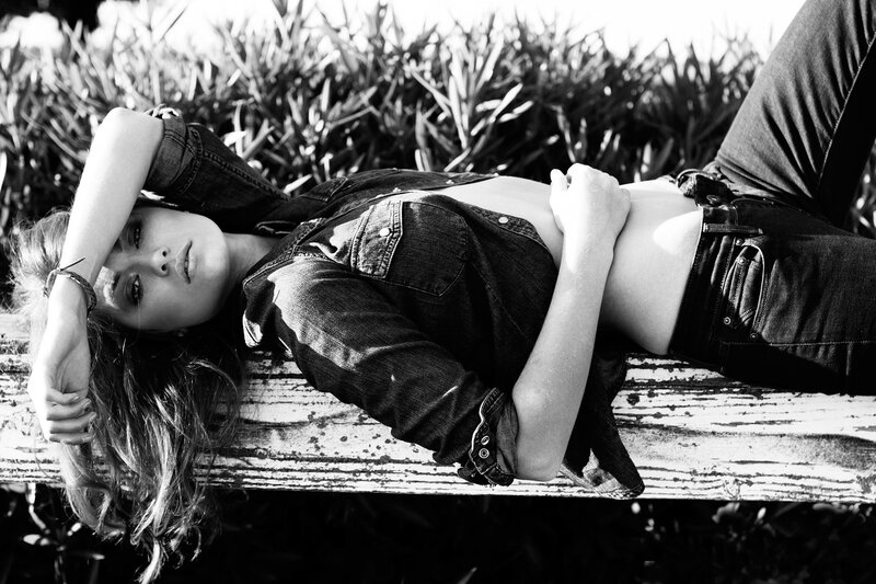 woman lying on wooden bench