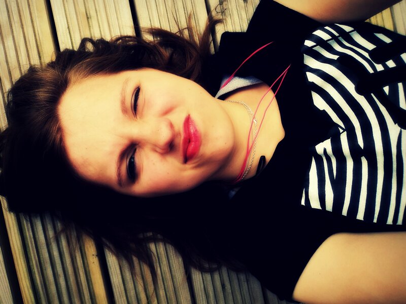 woman lying on wooden deck
