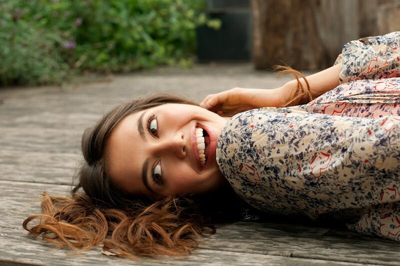 woman lying on wooden deck