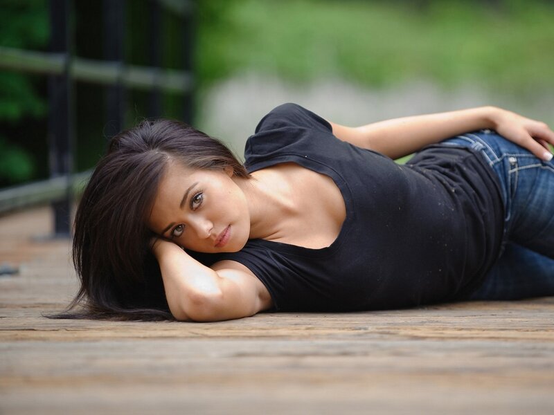 woman lying on wooden deck