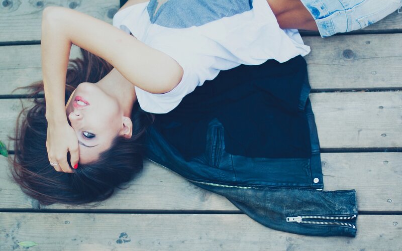 woman lying on wooden deck