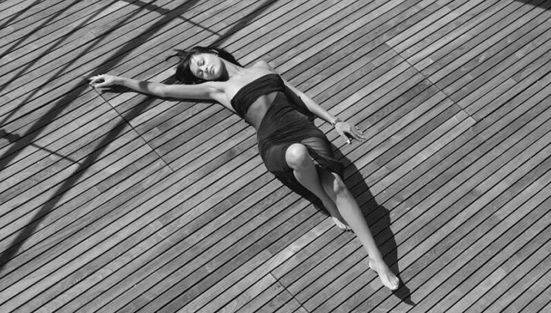 woman lying on wooden deck