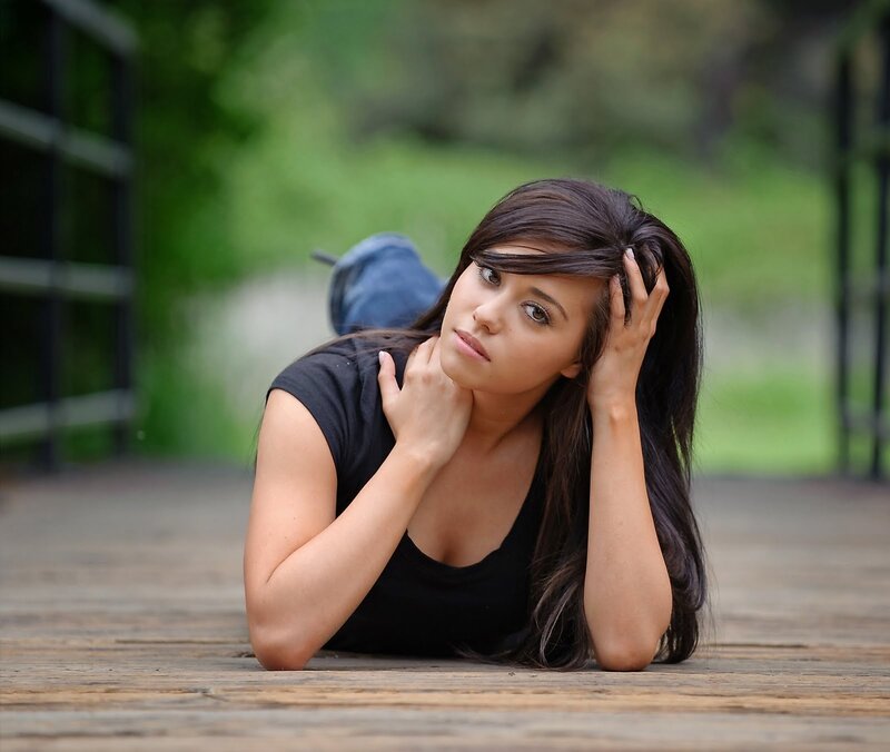 woman lying on wooden deck