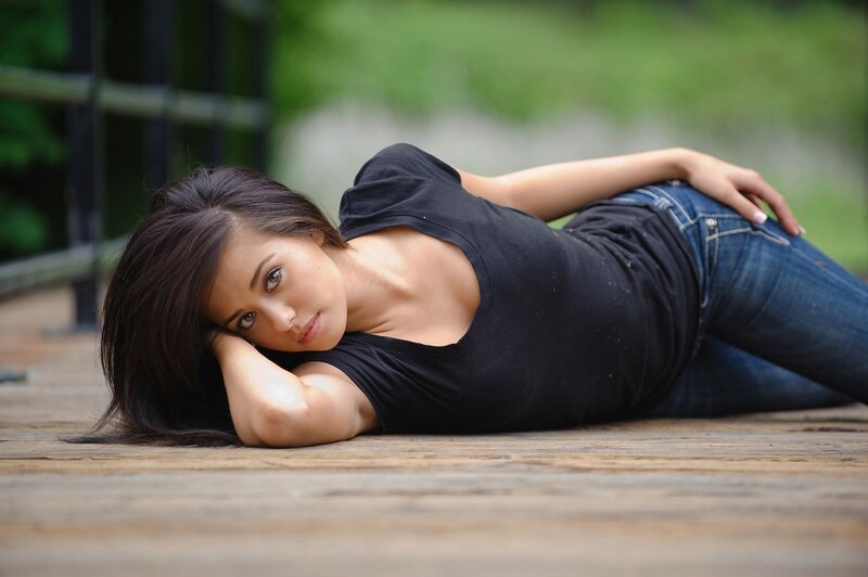 woman lying on wooden deck