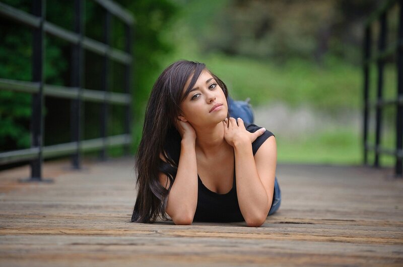 woman lying on wooden deck