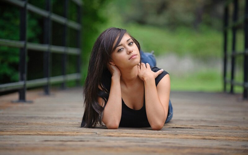 woman lying on wooden deck