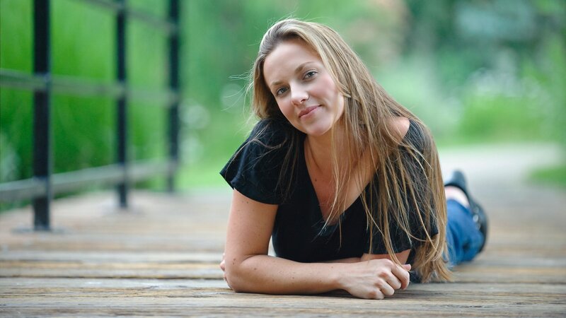 woman lying on wooden deck