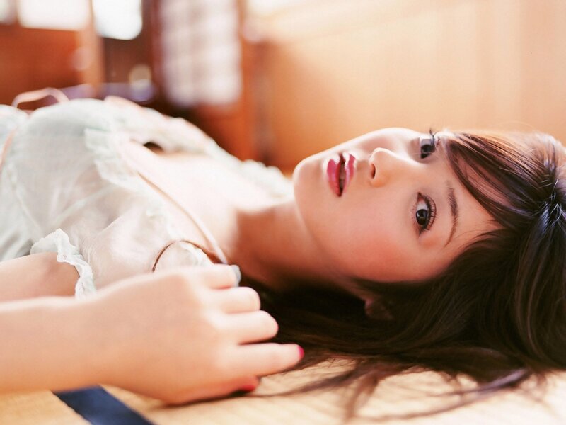woman lying on wooden floor