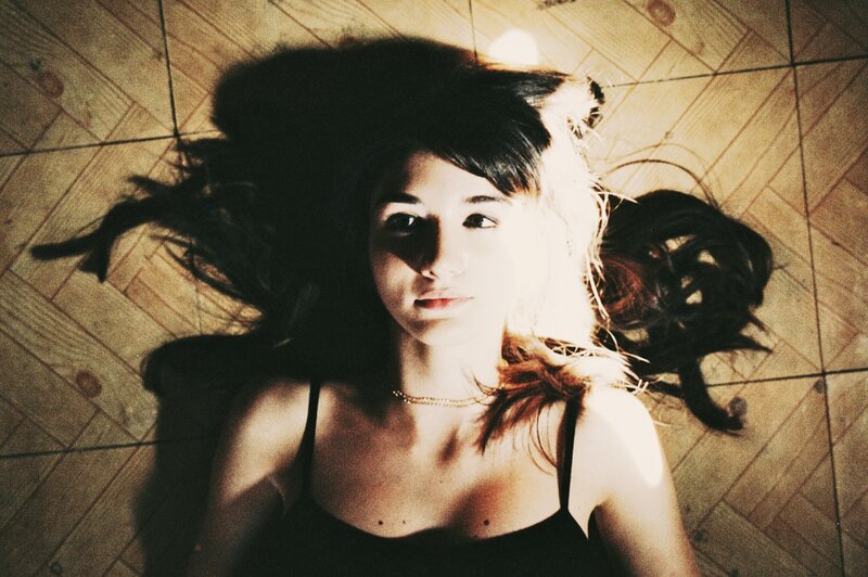 woman lying on wooden floor