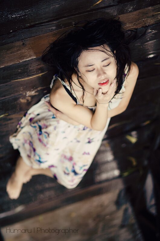woman lying on wooden floor