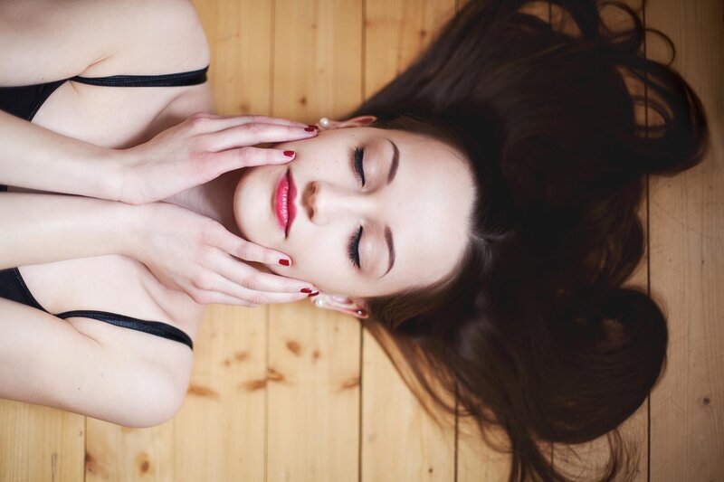woman lying on wooden floor