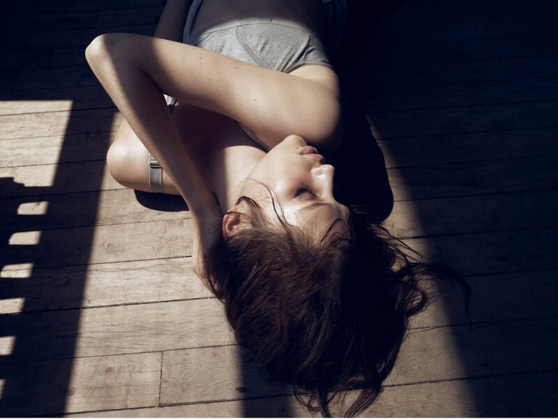 woman lying on wooden floor