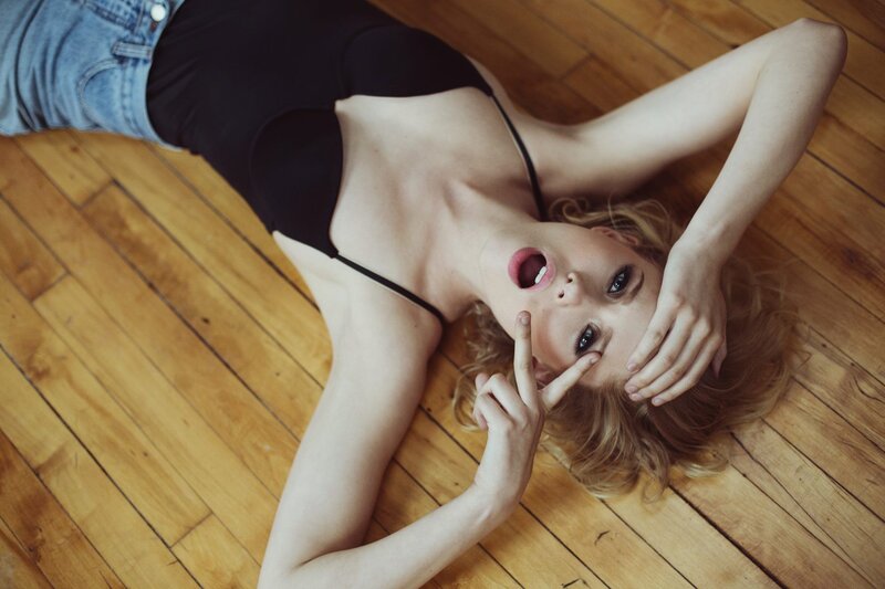 woman lying on wooden floor