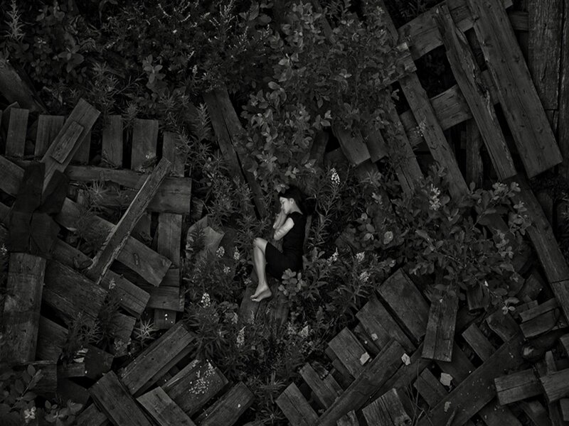 Woman Lying on Wooden Pallets