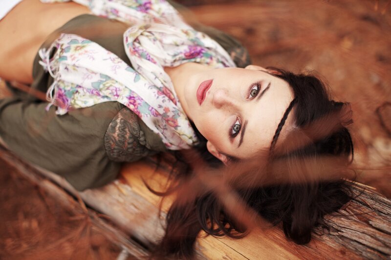 woman lying on wooden surface