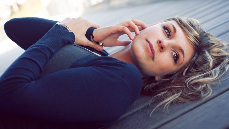 woman lying on wooden surface