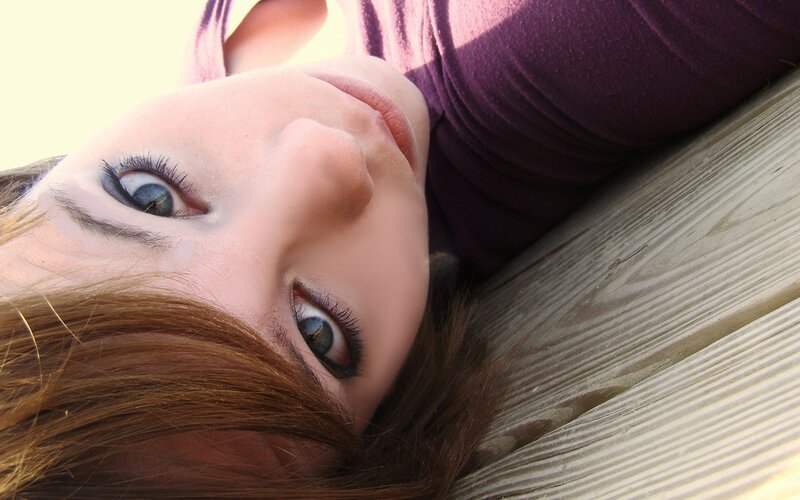 woman lying on wooden surface