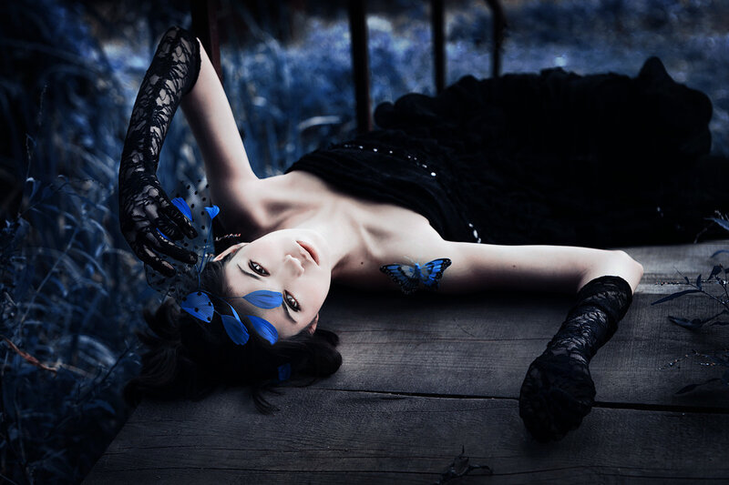 Woman Lying on Wooden Surface — Black, Dramatic