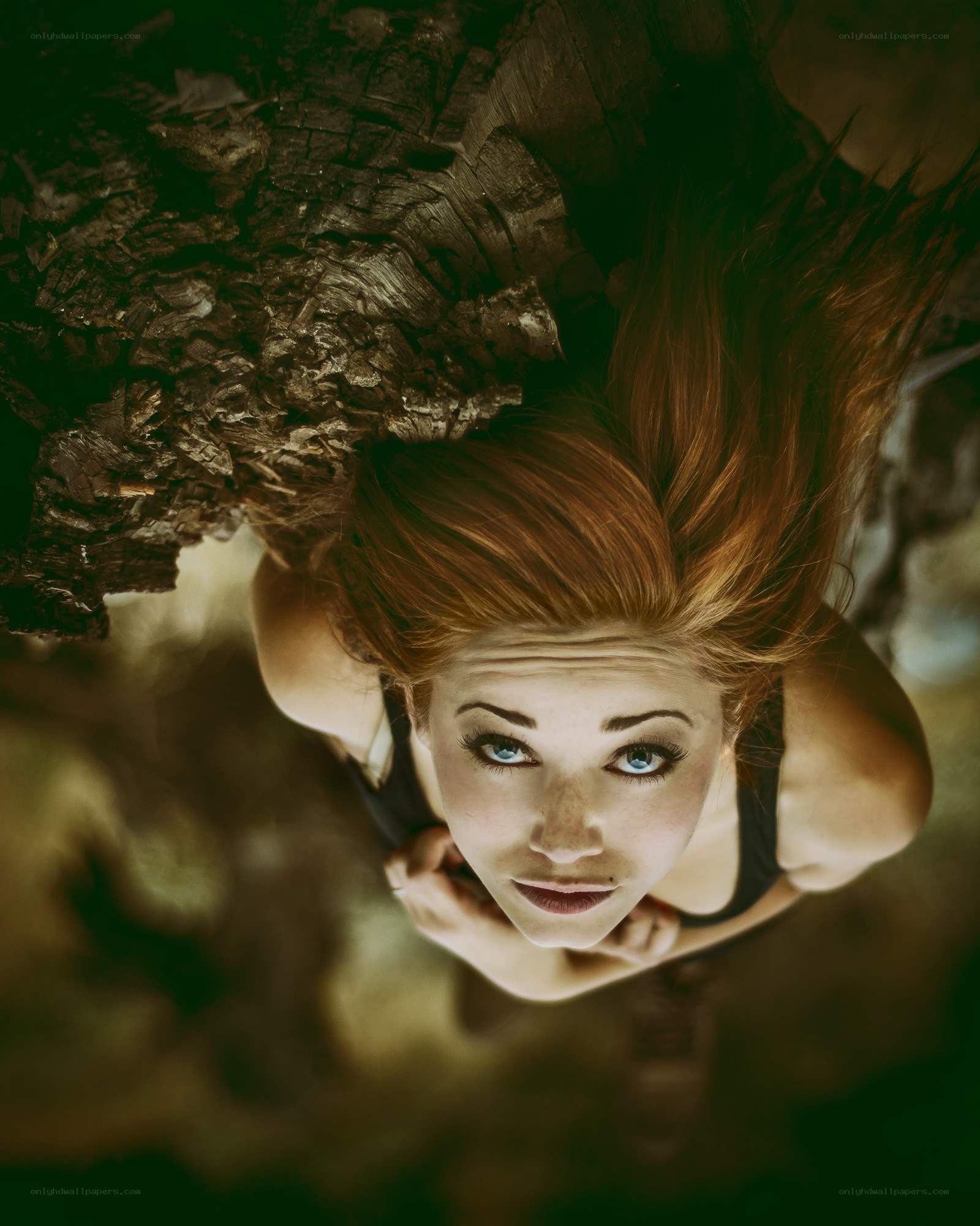 woman lying under tree