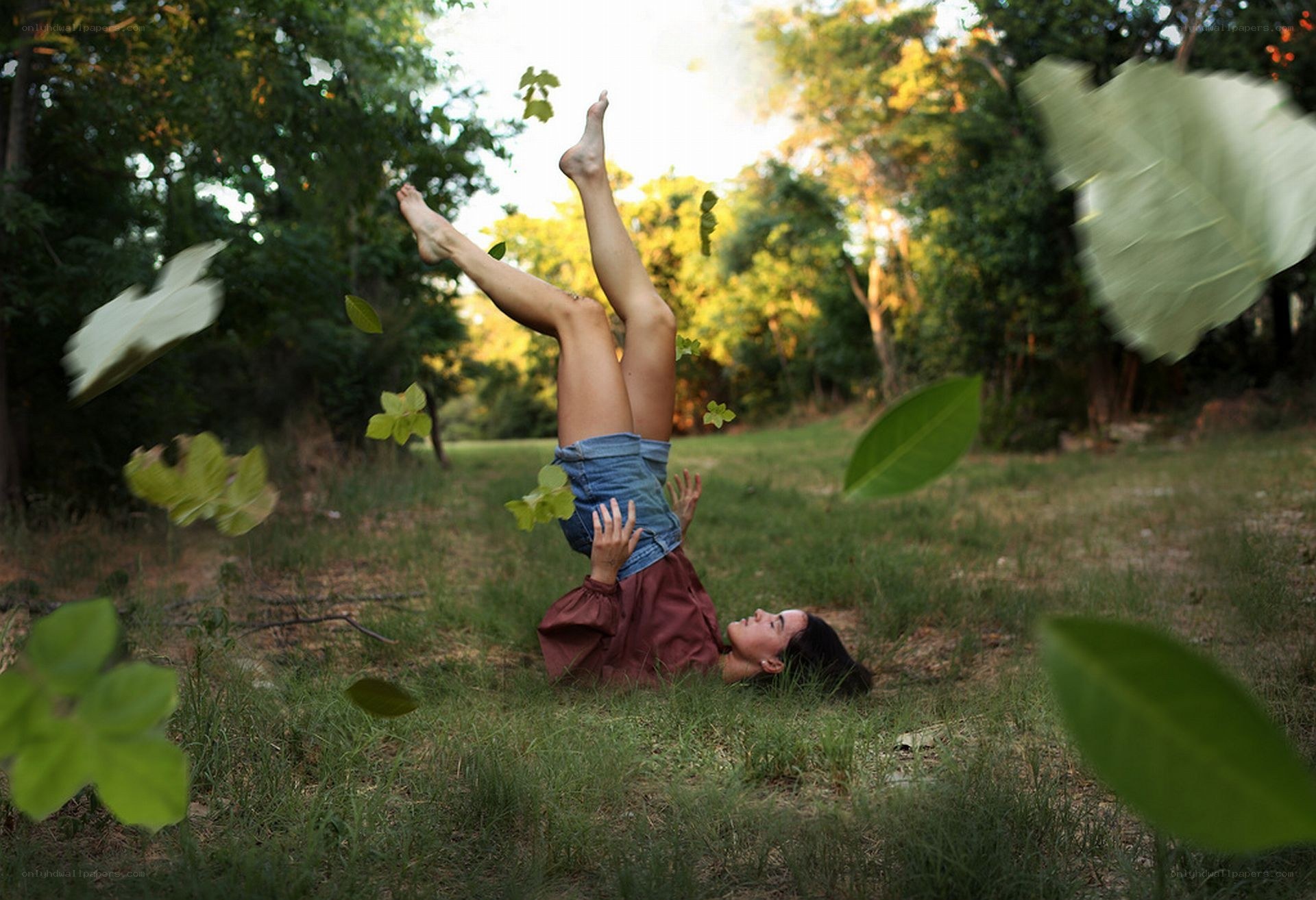 Woman lying upside down in a forest