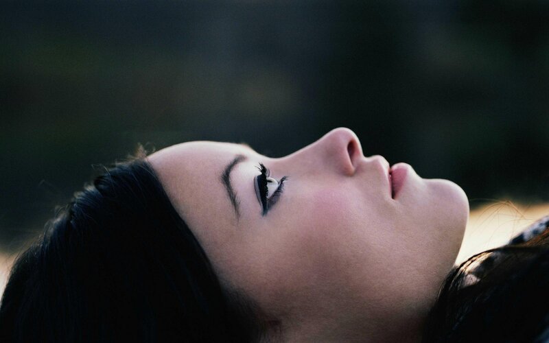 woman lying with eyes closed