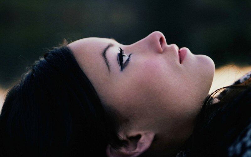 woman lying with eyes closed