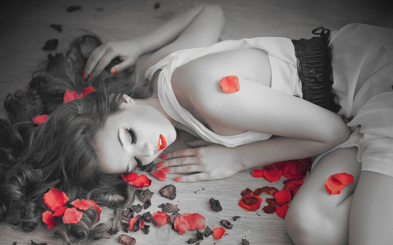 woman lying with rose petals